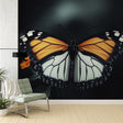 Butterfly wall mural creating dramatic impact in modern living room with dark furniture and warm lighting