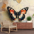 Butterfly wall mural featuring orange and black wings creates dramatic impact in a modern living room with natural light