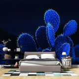 Blue glowing cactus wallpaper creating a magical atmosphere in a modern living room with minimalist furniture