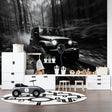 Black and white car wallpaper creating drama in modern living room with grey sofa and minimal decor