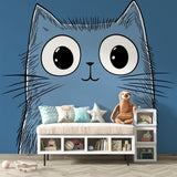 Cartoon blue cat wallpaper with big eyes creates a playful atmosphere in a modern nursery with white furniture
