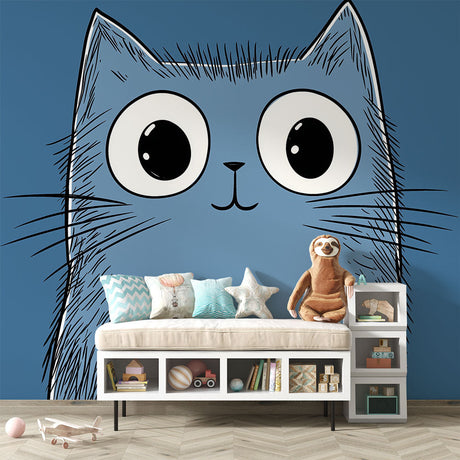 Cartoon blue cat wallpaper with big eyes creates a playful atmosphere in a modern nursery with white furniture