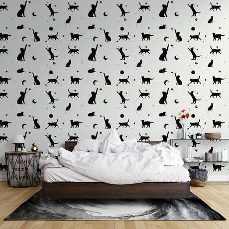 Modern living room with black cat silhouette wallpaper showing cats and moons pattern creating a cozy atmosphere