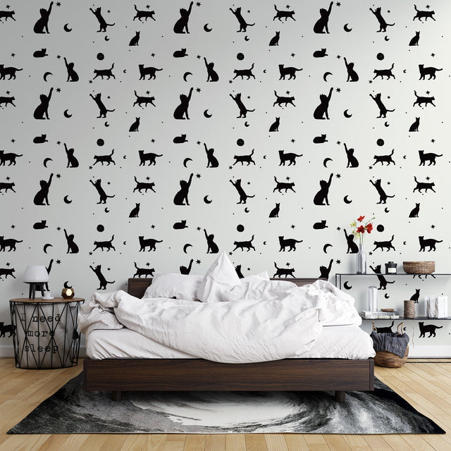 Modern living room with black cat silhouette wallpaper showing cats and moons pattern creating a cozy atmosphere
