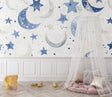 Celestial wallpaper with blue moons and stars creating a magical atmosphere in a modern nursery