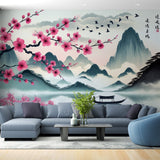 Cherry blossom wall mural creating depth in a modern living room, pink petals frame a serene mountain lake view