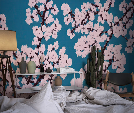 Cherry blossom wallpaper in modern living room with teal accents and natural light