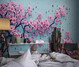 Cherry blossom wallpaper bringing spring feel to modern living room with grey sofa and natural light