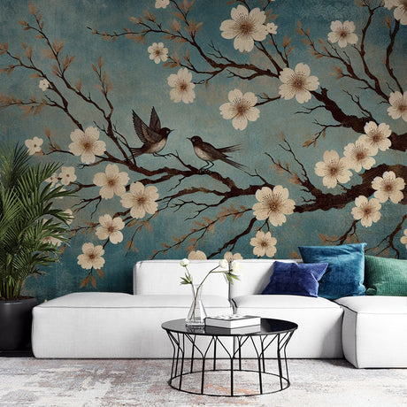 Cherry blossom wall mural with birds displayed in a bright living room, showing the scale and impact of the Asian floral design