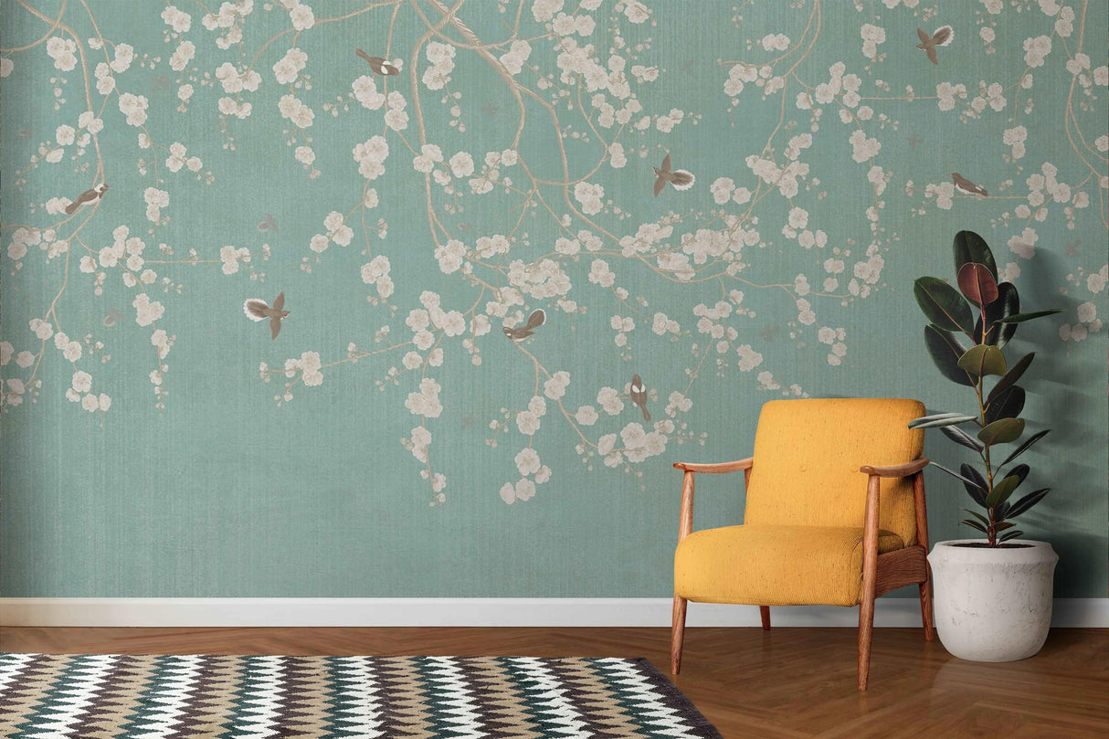 Cherry blossom wallpaper with birds shown in a bright living room, mint green walls creating a fresh spring atmosphere