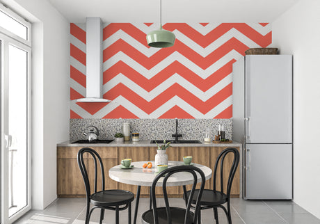 Modern chevron wallpaper in red and white brightening a minimalist living room with clean lines and natural light