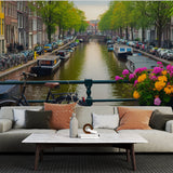 Amsterdam canal mural wallpaper creating depth in a bright modern living room with white furniture and natural light