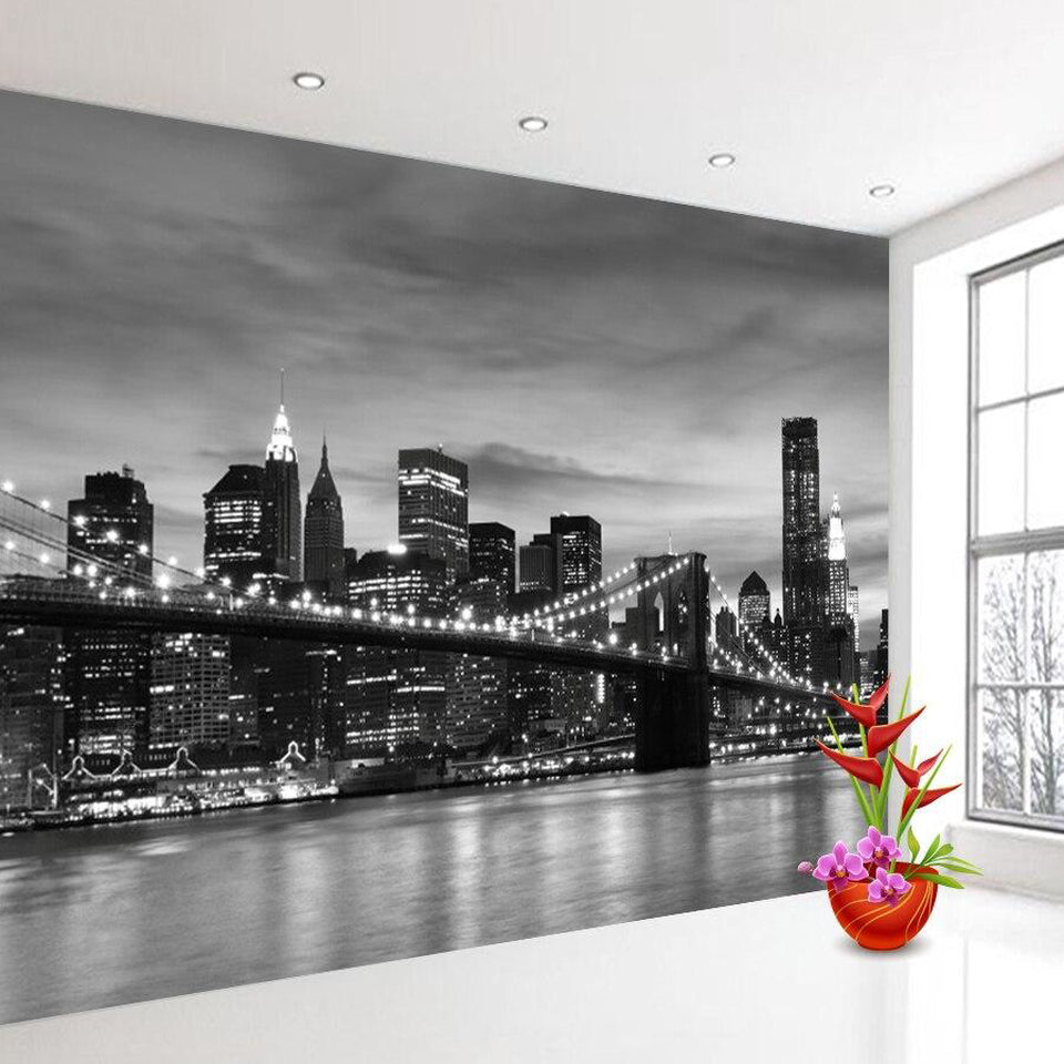 New York skyline wallpaper in modern living room, creating dramatic black and white focal point above grey sofa