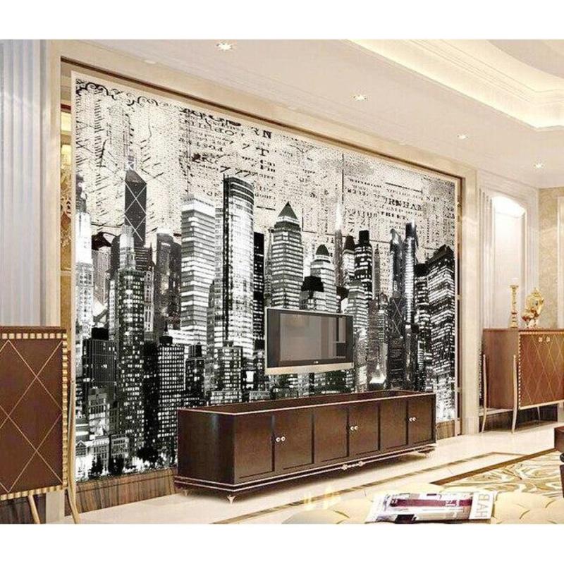 Black and white city skyline wallpaper creating dramatic impact in modern living room with grey sofa and minimal decor