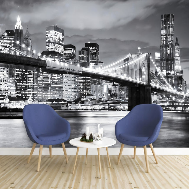 Black and white Brooklyn Bridge wallpaper creating drama in modern living room with grey sofa