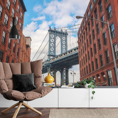 Manhattan Bridge wallpaper mural styled in modern minimalist living room with grey sofa and industrial lighting