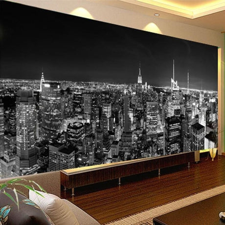 Black and white New York skyline wallpaper creating depth in modern living room with grey sofa and minimal decor