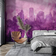Purple watercolor city skyline mural in modern minimalist living room with grey sofa
