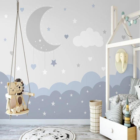 Cloud nursery wallpaper with moon and stars bringing calm to a modern nursery with white furniture