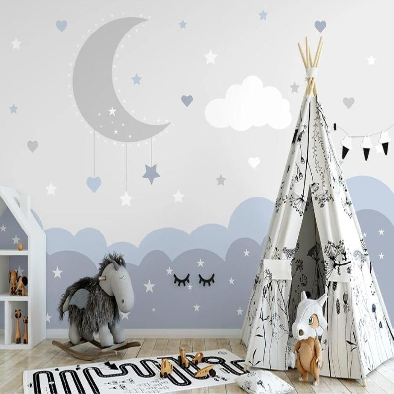 Moon and stars wallpaper creating a cozy reading nook in a toddler's bedroom
