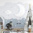 Night sky cloud wallpaper creating a cozy atmosphere in a modern nursery with soft lighting