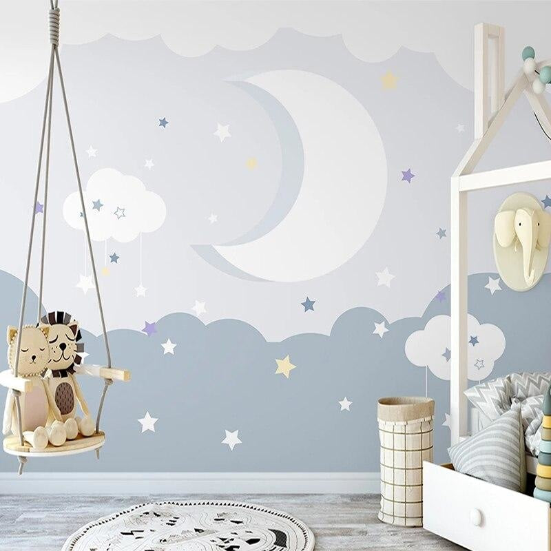 Moon and stars wallpaper bringing magic to a child's bedroom with gentle blue tones