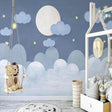 Dreamy night sky wallpaper creating a peaceful atmosphere in a modern nursery with soft lighting and gentle moon glow