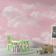 Pink cloud wallpaper mural creating a soft, dreamy atmosphere in a modern bedroom with white furniture