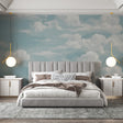 Cloud mural wallpaper creating a bright, open atmosphere in a modern living room with white furniture