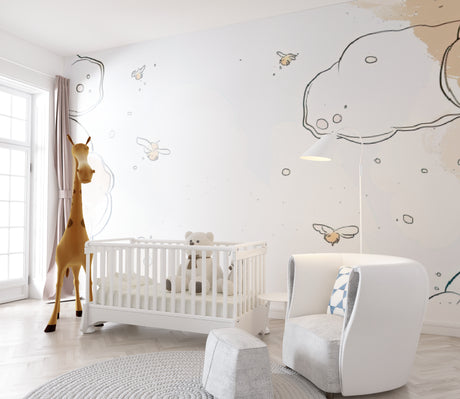 Cloud and bee nursery wallpaper in a bright modern nursery with white furniture and natural light