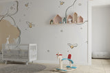 Children's bedroom featuring cloud and bee wallpaper with playful reading nook