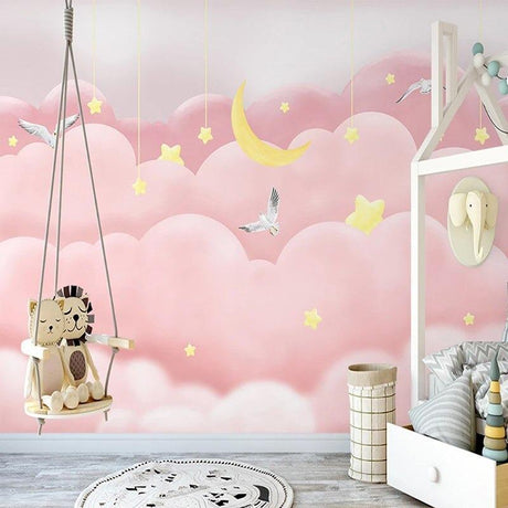 Pink cloud wallpaper with moon and stars creating a cozy atmosphere in a modern nursery