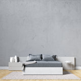 Modern concrete effect wallpaper in minimalist living room showing grey textured finish