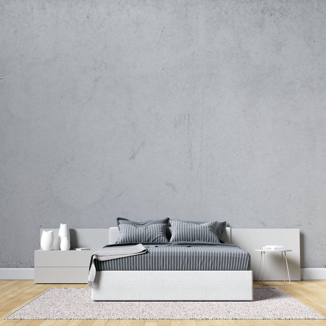 Modern concrete effect wallpaper in minimalist living room showing grey textured finish