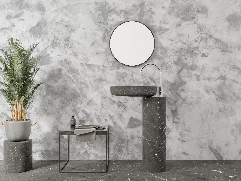 Modern concrete effect wallpaper in a minimalist living room with grey sofa and natural light
