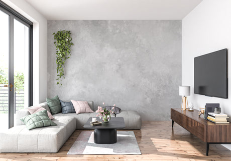 Modern concrete effect wallpaper in minimalist living room showing grey textured surface with natural lighting