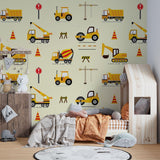 Daycare room transformed with yellow construction vehicle wallpaper showing excavators and cranes