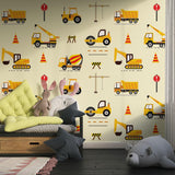 Play area decorated with construction site mural featuring safety signs and yellow trucks