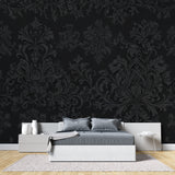 Black and silver baroque wallpaper in modern dining room with crystal chandelier