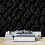 Elegant entryway with black damask pattern wallpaper and gold-framed mirror