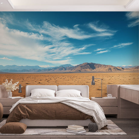 Desert landscape wallpaper creating depth in a modern living room with clean furniture and natural light