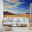 Desert landscape wallpaper creating depth in a modern living room, warm earth tones complement contemporary furniture