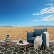 Desert landscape wallpaper in modern minimalist living room, showing cracked earth pattern and mountain vista