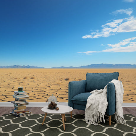 Desert landscape wallpaper in modern minimalist living room, showing cracked earth pattern and mountain vista