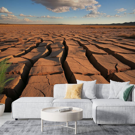 Desert landscape wallpaper creating drama in a modern minimalist living room with natural light and earth-toned furniture