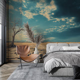 Desert landscape wallpaper shown in a modern minimalist living room, creating a peaceful atmosphere with golden earth tones