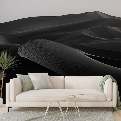 Black and white desert dunes wallpaper creating a dramatic focal point in a modern minimalist living room with clean lines