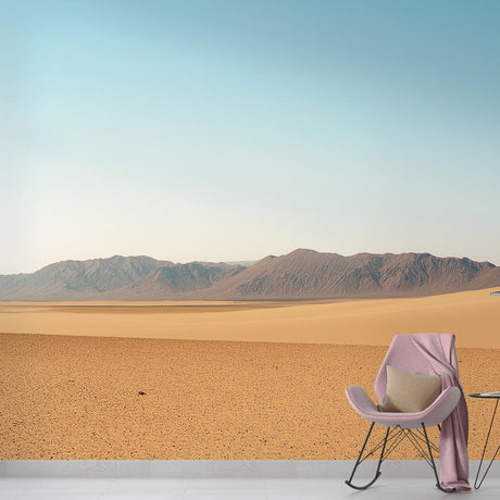 Desert landscape wallpaper creating a calm atmosphere in a modern living room with minimal furniture