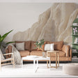 Desert landscape wallpaper creating a calming atmosphere in a modern living room with natural stone formations in warm beige tones