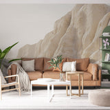 Desert landscape wallpaper creating a calming atmosphere in a modern living room with natural stone formations in warm beige tones